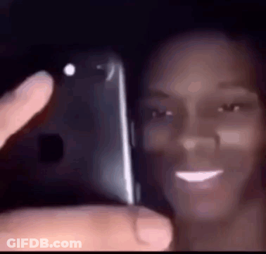 A Woman Is Taking A Selfie With Her Phone . GIF