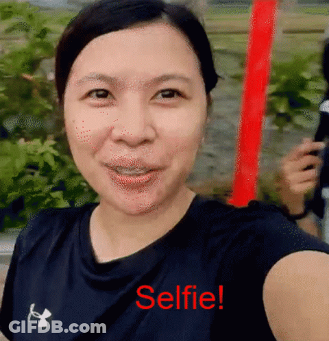 A Woman Is Taking A Selfie With The Words Selfie Written In Red GIF