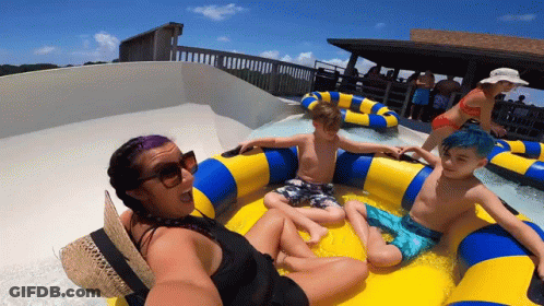 A Woman Is Taking A Selfie With Two Children On A Raft GIF