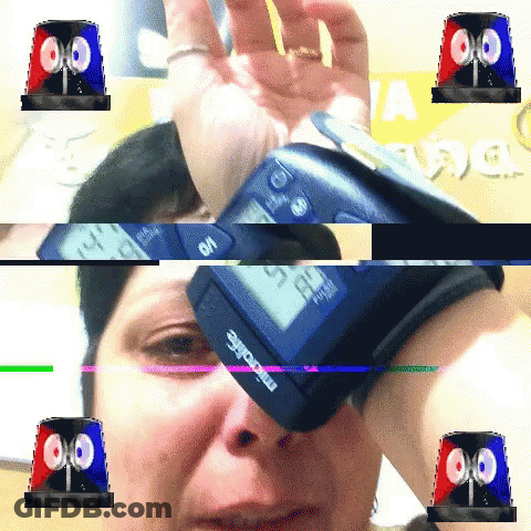 A Woman Is Taking Her Blood Pressure With A Microlife Device On Her Wrist GIF