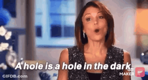 A Woman Is Talking About A Hole In The Dark While Wearing A Sequined Top . GIF