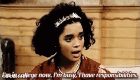 A Woman Is Talking About Her Responsibilities While Standing In Front Of A Wooden Wall . GIF