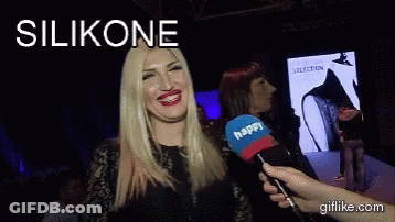 A Woman Is Talking Into A Microphone With The Word Silikone Above Her GIF