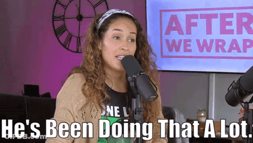A Woman Is Talking Into A Microphone With The Words He 'S Been Doing That A Lot Behind Her GIF