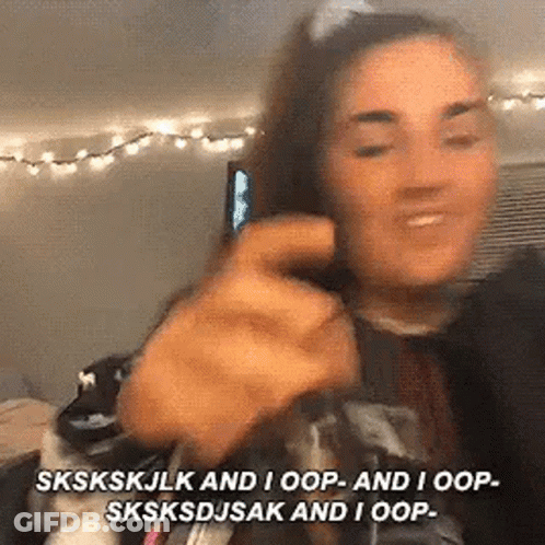 A Woman Is Talking On A Cell Phone And Making A Funny Face While Holding A Cell Phone In Her Hand . GIF