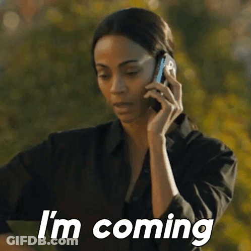 A Woman Is Talking On A Cell Phone And Says `` I 'M Coming '' GIF