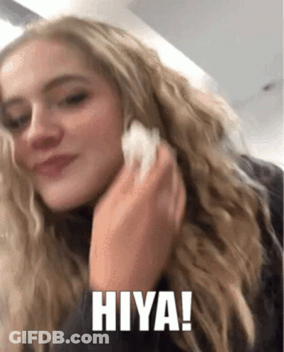 A Woman Is Talking On A Cell Phone And The Words Hiya Are On The Screen GIF
