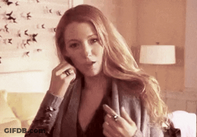 A Woman Is Talking On A Cell Phone In A Living Room While Wearing A Ring On Her Finger . GIF