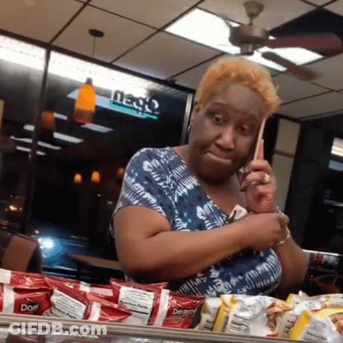 A Woman Is Talking On A Cell Phone In A Restaurant With Doritos In Front Of Her GIF