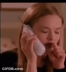 A Woman Is Talking On A Cell Phone While Holding Her Nose . GIF