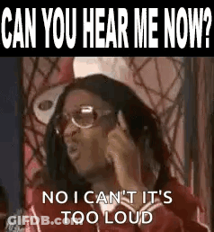 A Woman Is Talking On A Cell Phone While Wearing Glasses And A Red Jacket . GIF