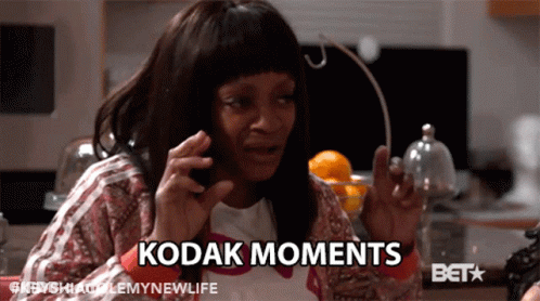 A Woman Is Talking On A Cell Phone With Kodak Moments Written On The Bottom GIF