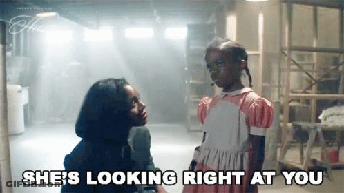 A Woman Is Talking To A Little Girl Who Is Looking Right At Her . GIF