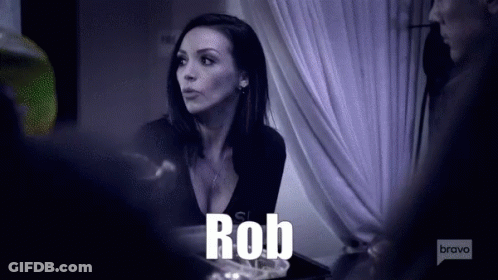 A Woman Is Talking To A Man And The Word Rob Is Visible GIF