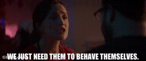 A Woman Is Talking To A Man In A Dark Room And The Words We Just Need Them To Behave Themselves Are Visible . GIF