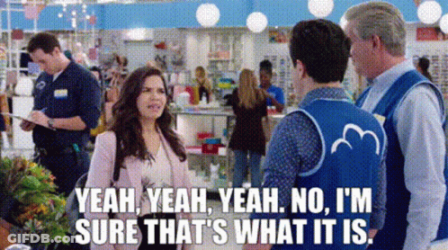 A Woman Is Talking To A Man In A Store While A Man In A Blue Vest Says Yeah GIF
