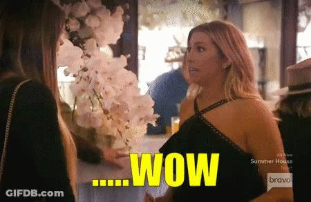 A Woman Is Talking To Another Woman And The Word Wow Is Visible GIF