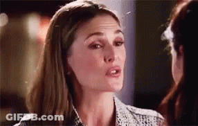 A Woman Is Talking To Another Woman In A Room And Looking At The Camera . GIF