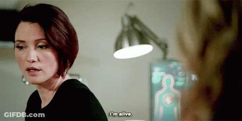 A Woman Is Talking To Another Woman In A Room And Says `` I 'M Alive . '' GIF