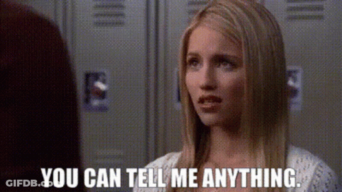 A Woman Is Talking To Another Woman In Front Of Lockers And Says `` You Can Tell Me Anything . '' GIF