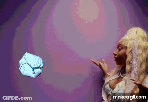 A Woman Is Throwing A Ball In The Air . GIF