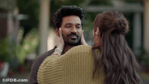 A Woman Is Touching A Man 'S Face In A Close Up . GIF