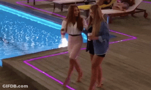 A Woman Is Walking A Dog Near A Swimming Pool GIF