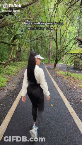 A Woman Is Walking Down A Path In The Woods With A Caption That Says I Was Walking And Found Something Cute GIF