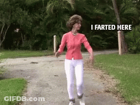 A Woman Is Walking Down A Path With The Words " I Farted Here " On The Bottom GIF