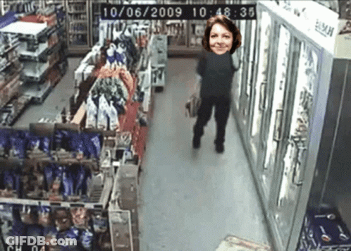 A Woman Is Walking Down A Store Aisle With The Date 10/06/2009 GIF