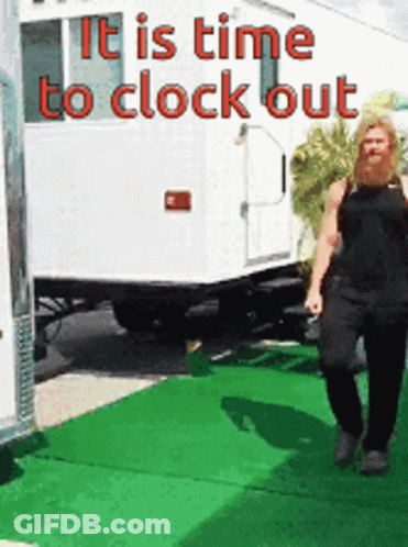 A Woman Is Walking In Front Of A Trailer That Says " It Is Time To Clock Out " GIF