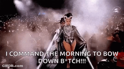 A Woman Is Walking On A Stage In Front Of A Crowd And Says `` Command The Morning To Bow Down B * Tch '' . GIF