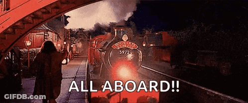 A Woman Is Walking Towards A Train With The Words All Aboard On The Bottom GIF