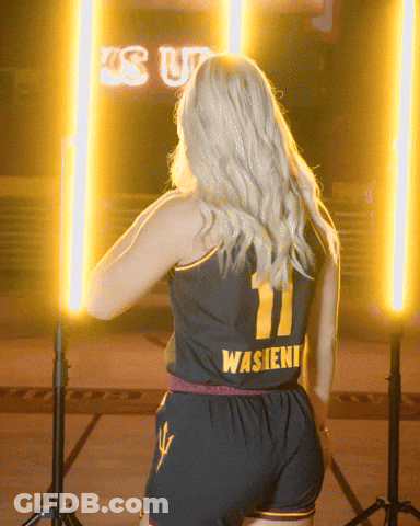 A Woman Is Wearing A Black Jersey With The Number 11 On It GIF