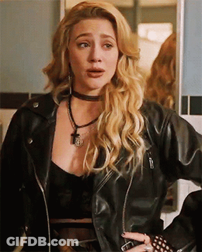 A Woman Is Wearing A Black Leather Jacket And A Choker Necklace . GIF