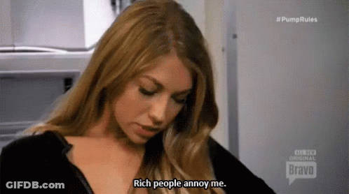 A Woman Is Wearing A Black Shirt And Saying `` Rich People Annoy Me . '' GIF