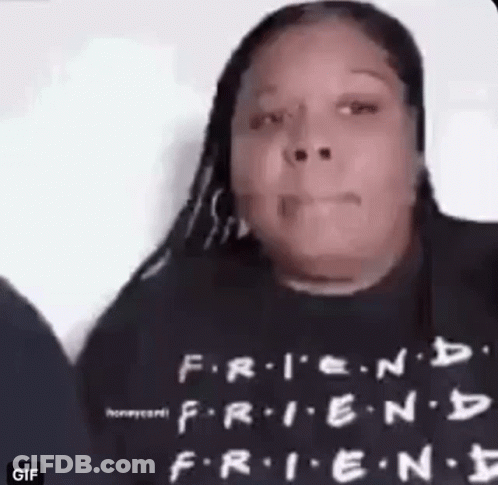 A Woman Is Wearing A Black T-Shirt With The Words `` Friends '' On It . GIF