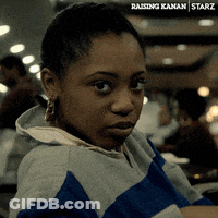 A Woman Is Wearing A Blue And Gray Striped Sweatshirt With The Word Starz On The Bottom Right GIF