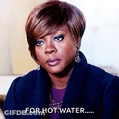 A Woman Is Wearing A Blue Coat And Earrings And Says `` For Hot Water '' . GIF