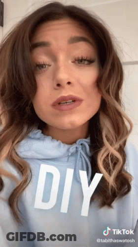 A Woman Is Wearing A Blue Hoodie With The Word Diy On It GIF