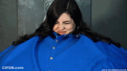 A Woman Is Wearing A Blue Jacket That Is Very Big GIF