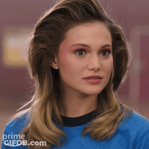 A Woman Is Wearing A Blue Shirt With An Amazon Prime Logo On It GIF