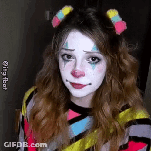 A Woman Is Wearing A Clown Costume And Making A Sad Face . GIF