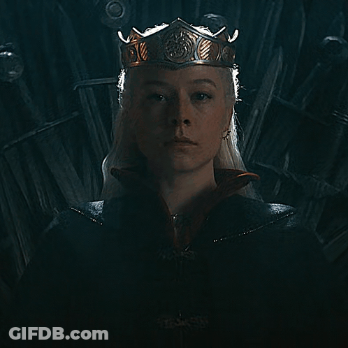 A Woman Is Wearing A Crown And A Black Cape GIF