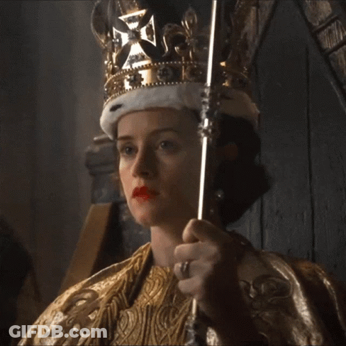 A Woman Is Wearing A Crown And Holding A Scepter GIF