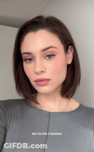 A Woman Is Wearing A Grey Shirt With The Words " No Filter Tuesday " On The Bottom GIF