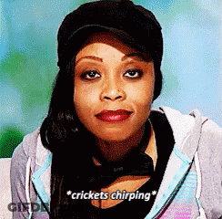 A Woman Is Wearing A Hat And A Hoodie And Says Crickets Chirping GIF