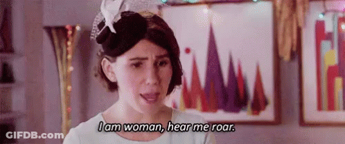 A Woman Is Wearing A Hat And A White Dress And Says `` I Am Woman , Hear Me Roar '' . GIF
