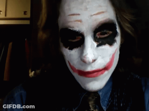 A Woman Is Wearing A Joker Mask And Smiling At The Camera GIF