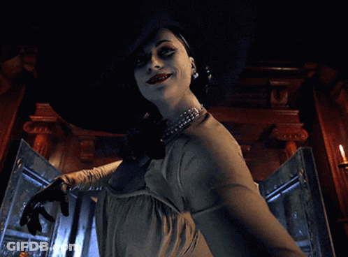 A Woman Is Wearing A Large Hat And Holding A Knife GIF
